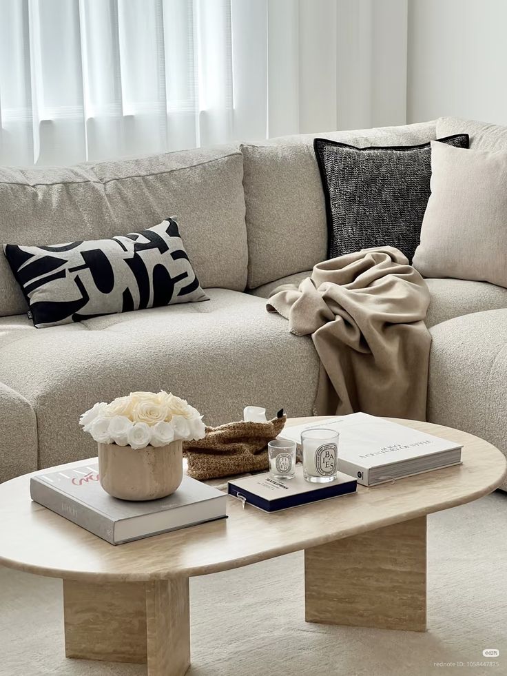 Luxe Travertine Oval Coffee Table in a Warm Minimalist Living Room Setting.
This high-end furniture piece focuses on a