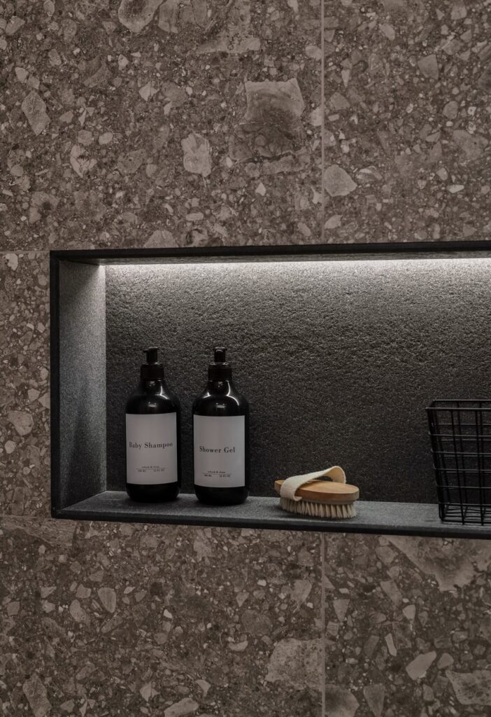 Luxe Contemporary Recessed Shower Niche with Integrated LED Lighting and Large-Format Terrazzo Tiling.