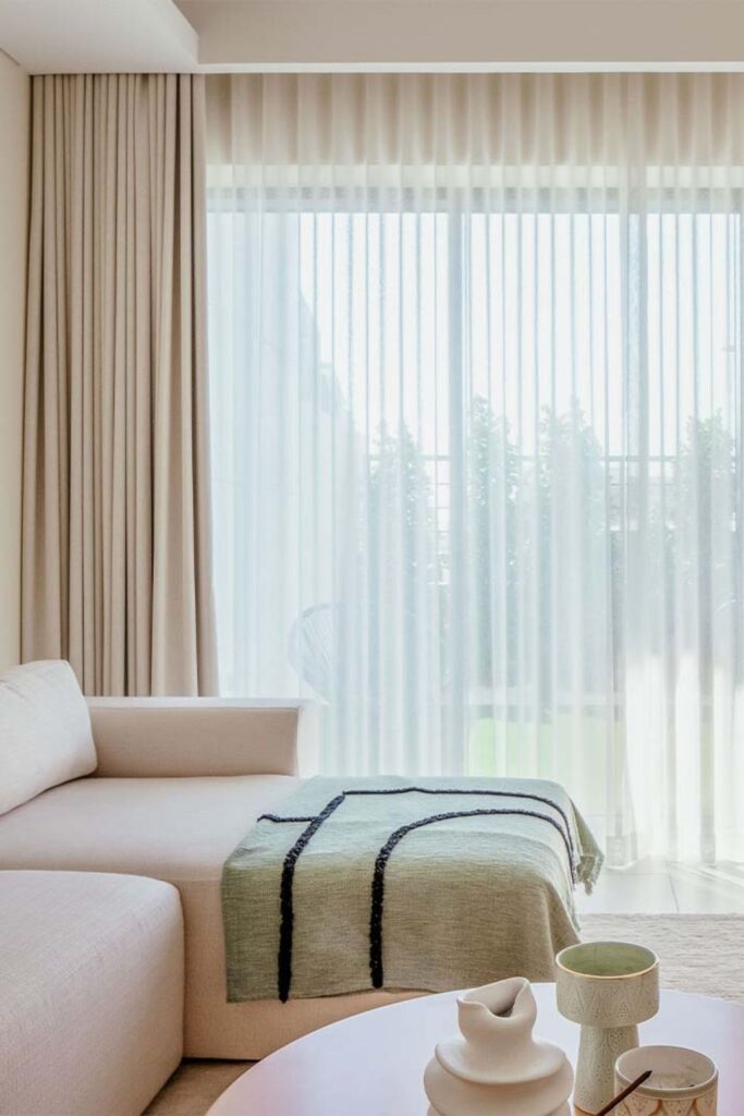 Luxurious Neutral Living Space with S-Fold Sheer & Blackout Wave Curtains.