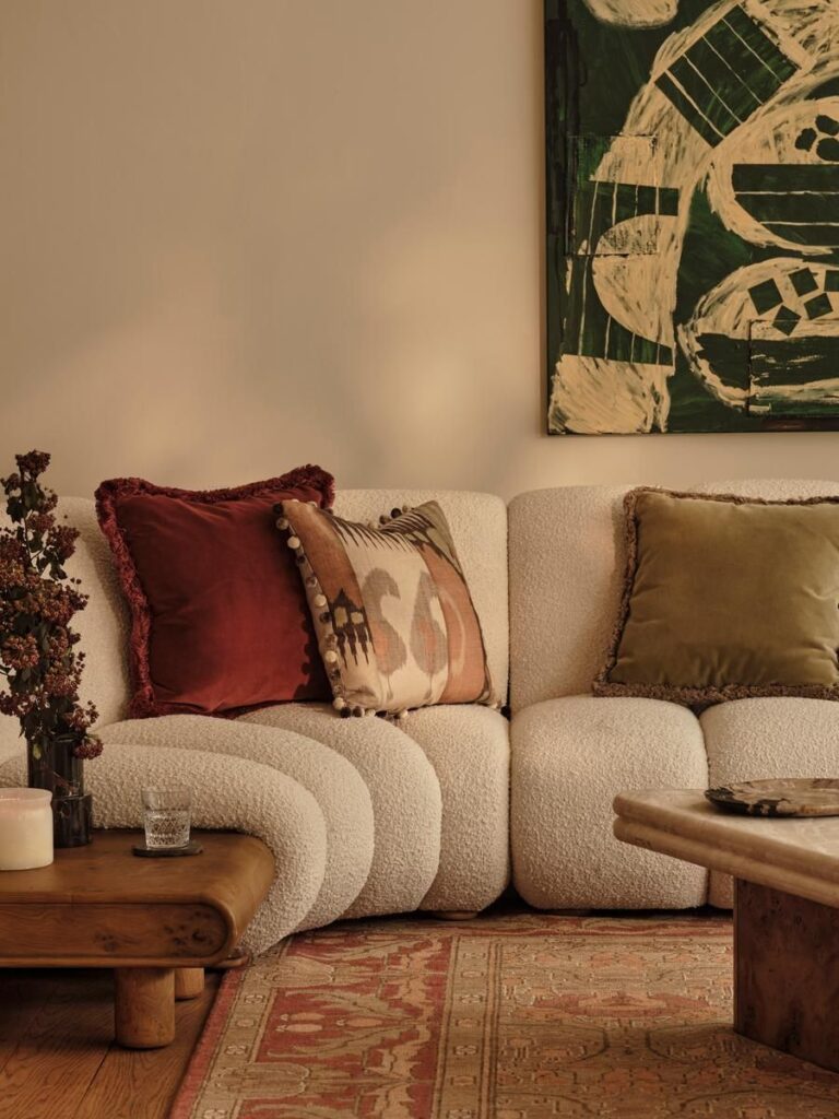 Luxe Organic Living Room with Curved Bouclé Sectional and Margeaux Fringed Velvet Cushions.