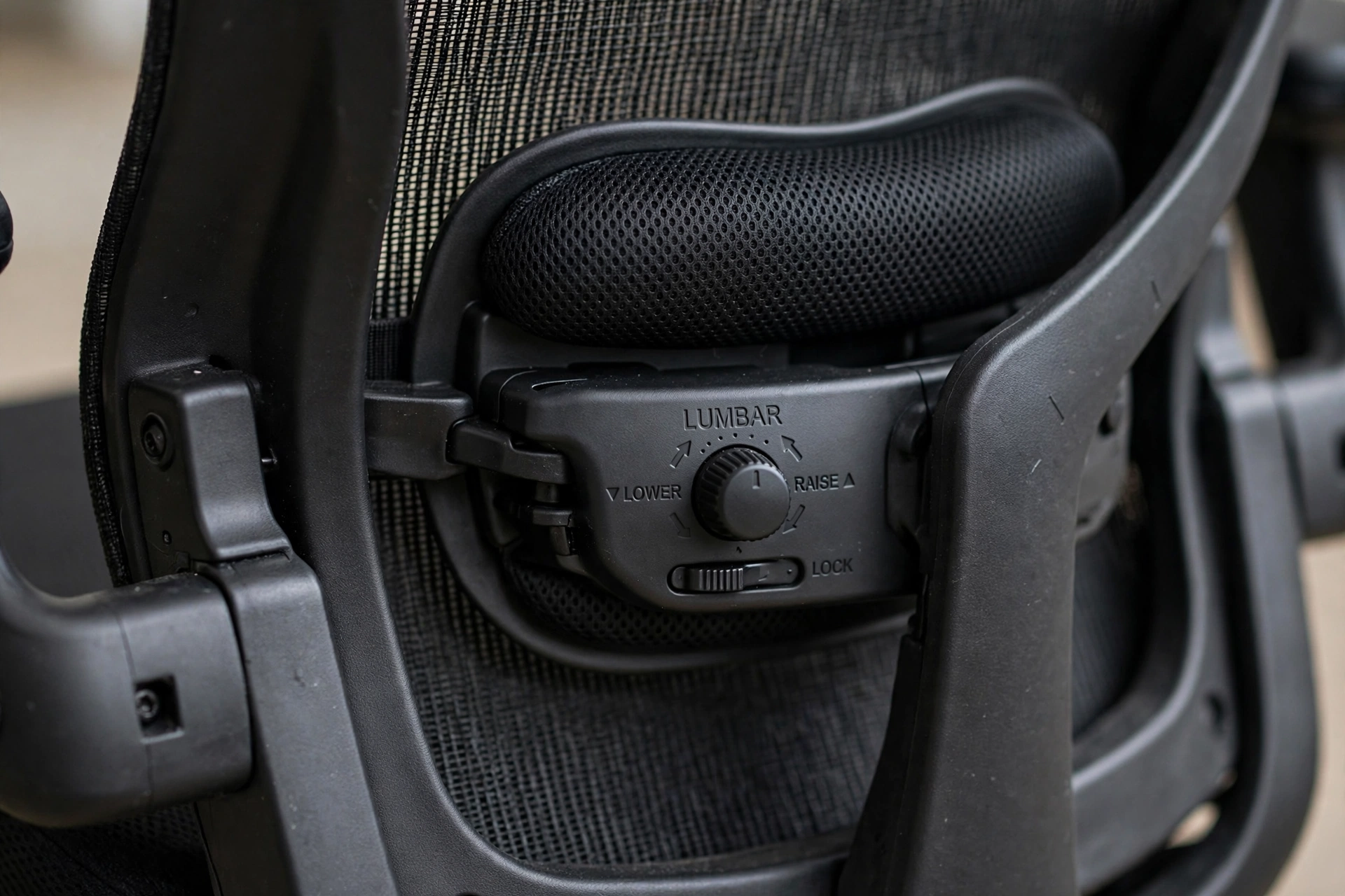 Close-up of adjustable lumbar support on an ergonomic office chair
