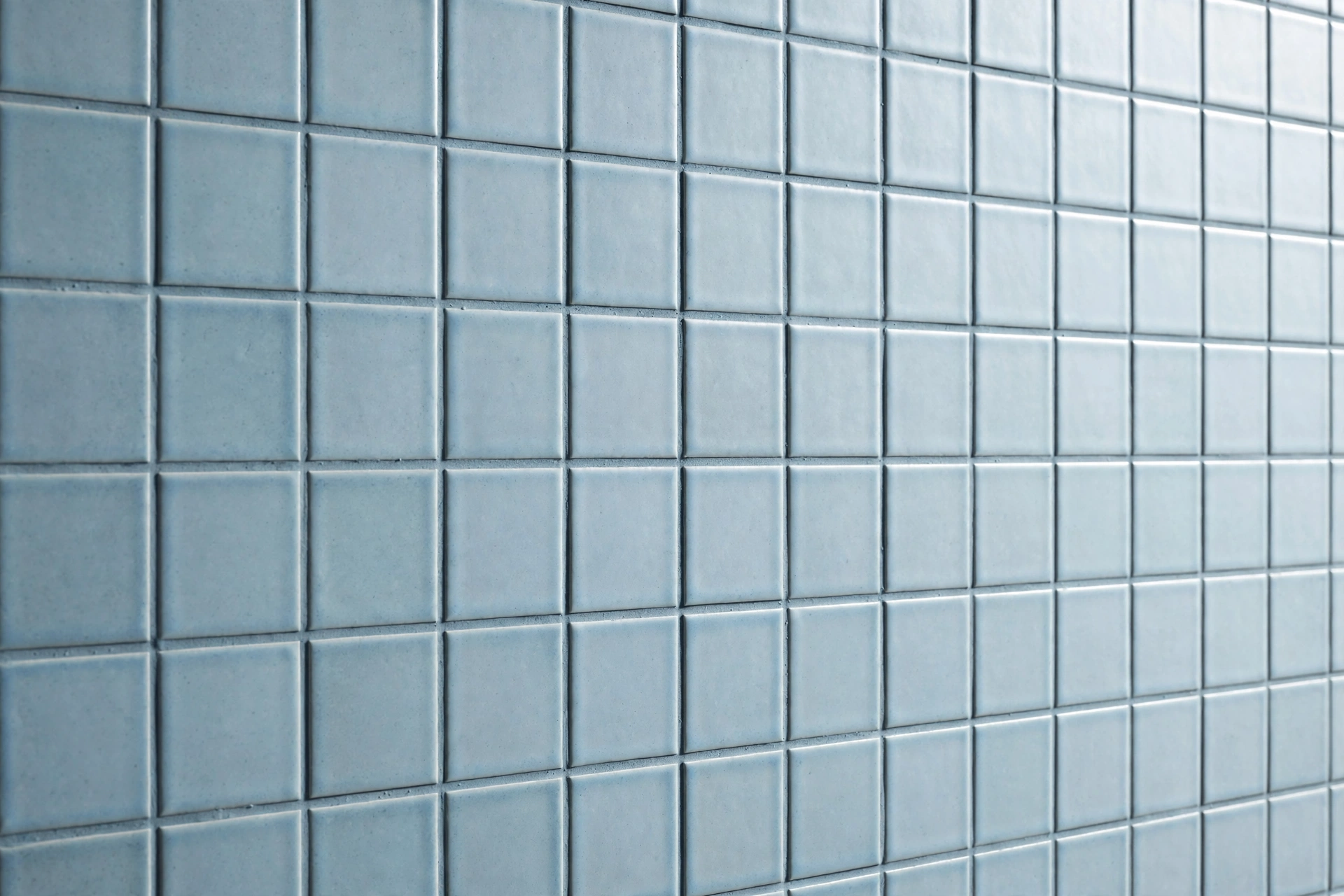 Soft blue bathroom tile with matching tonal blue-gray grout