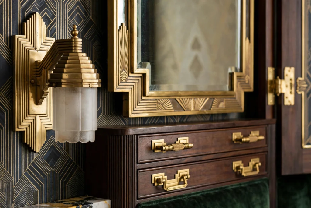 Art deco bedroom design ideas with brass sconces, mirror frame and gold hardware details