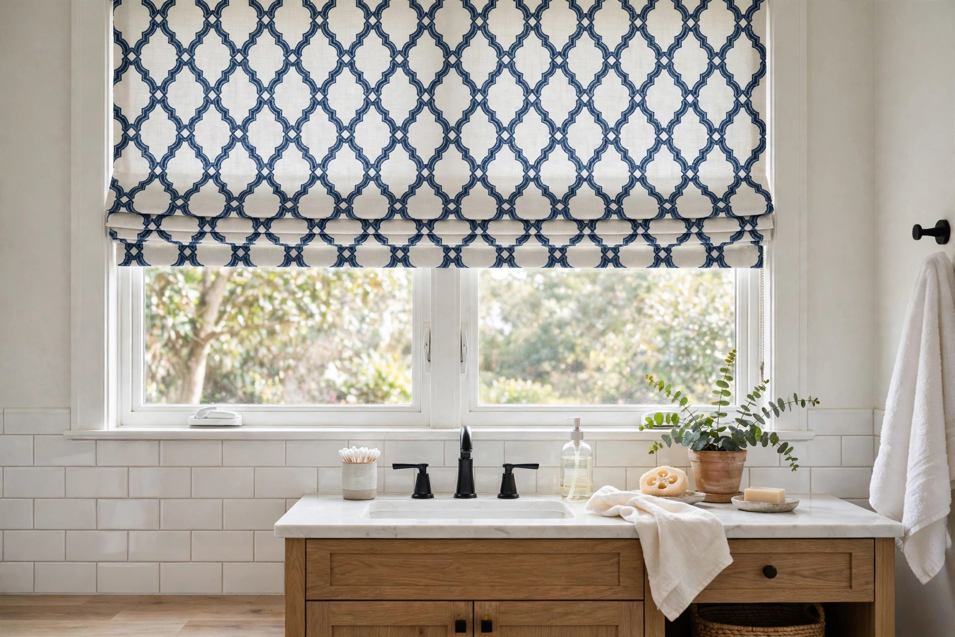 Patterned Roman shade in outdoor fabric on a bathroom window