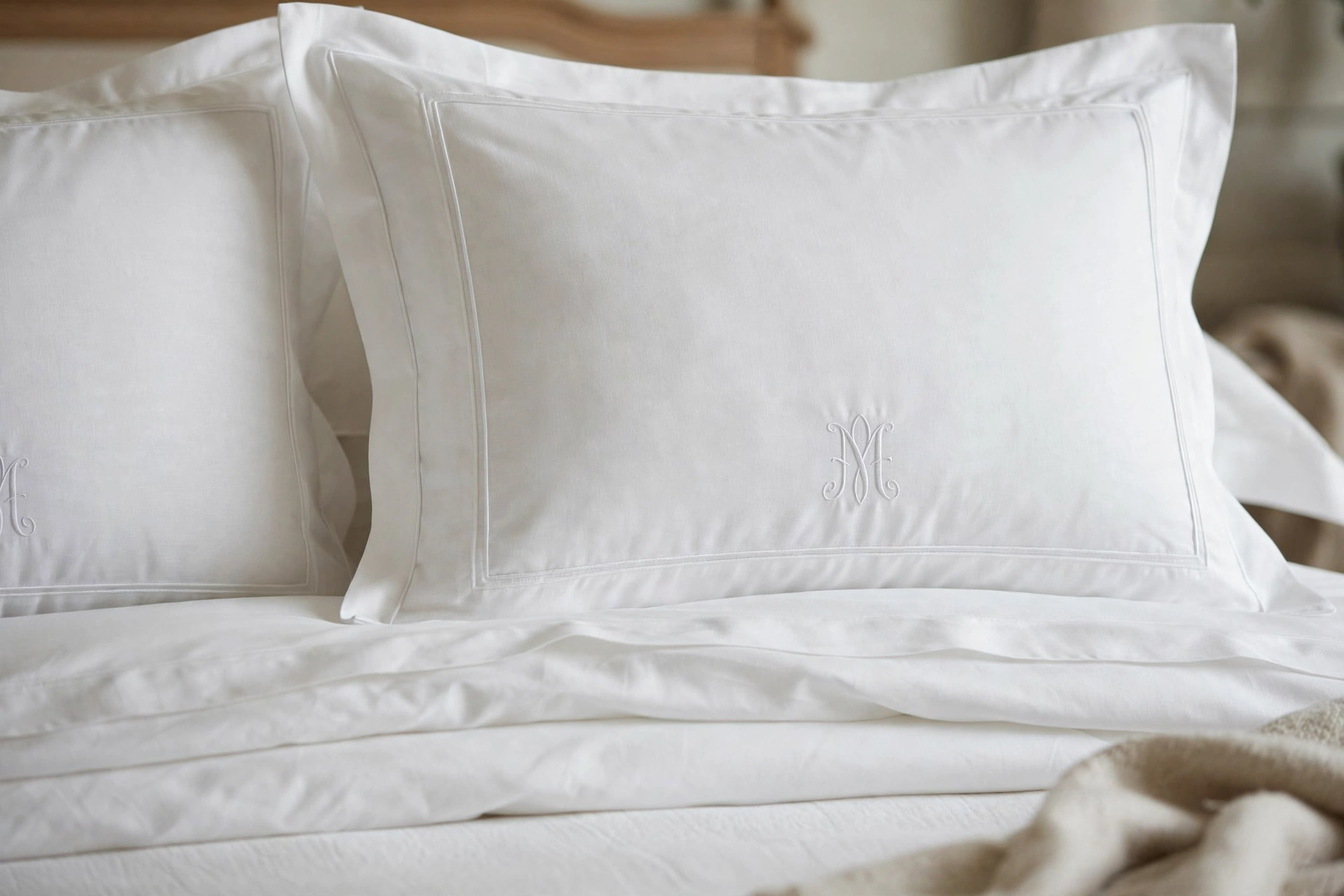 Traditional bedroom design ideas with tailored bedding, piped shams and monogram details