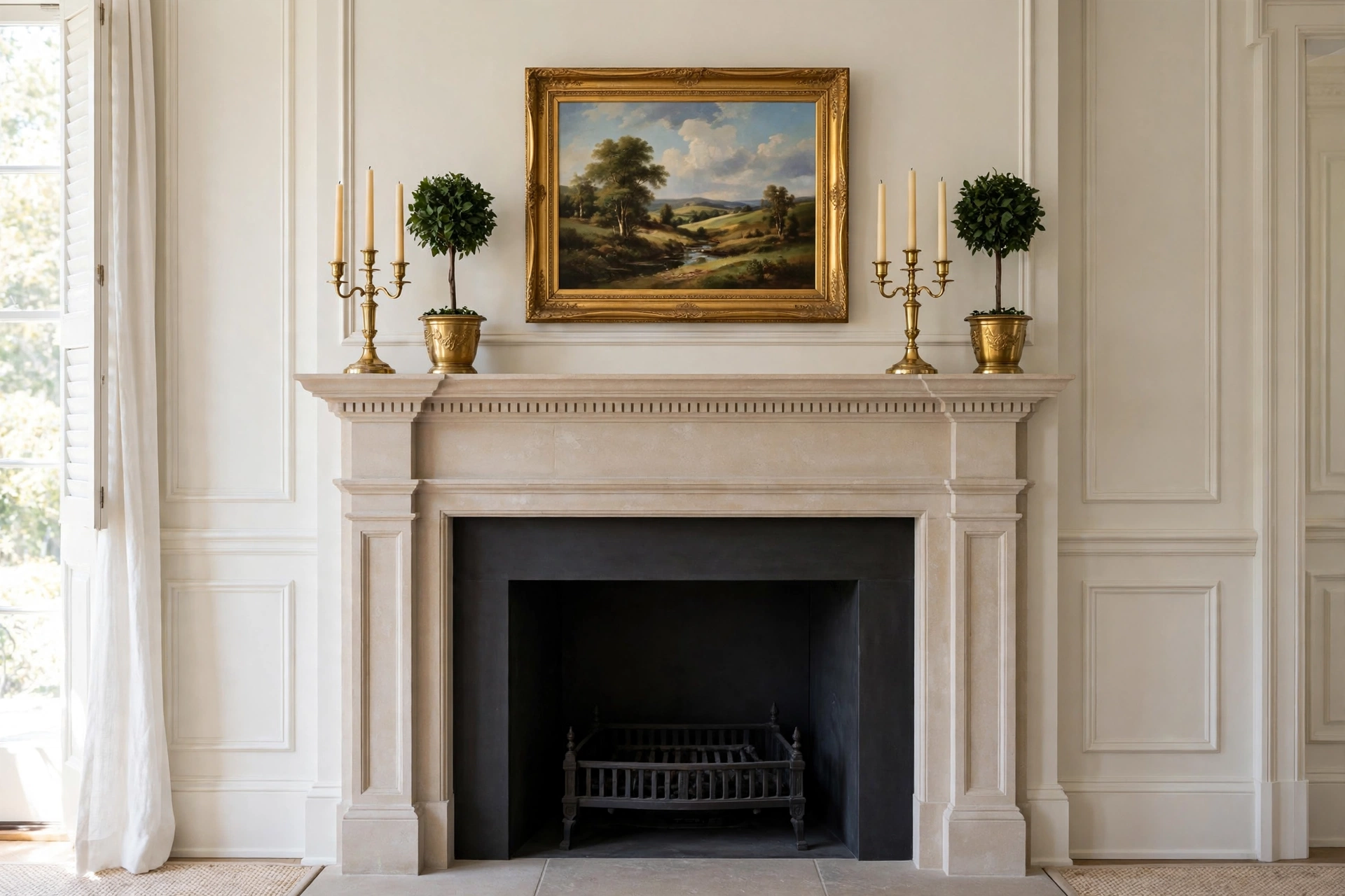 Fireplace mantel decor ideas with classic symmetrical candlesticks and topiaries.
