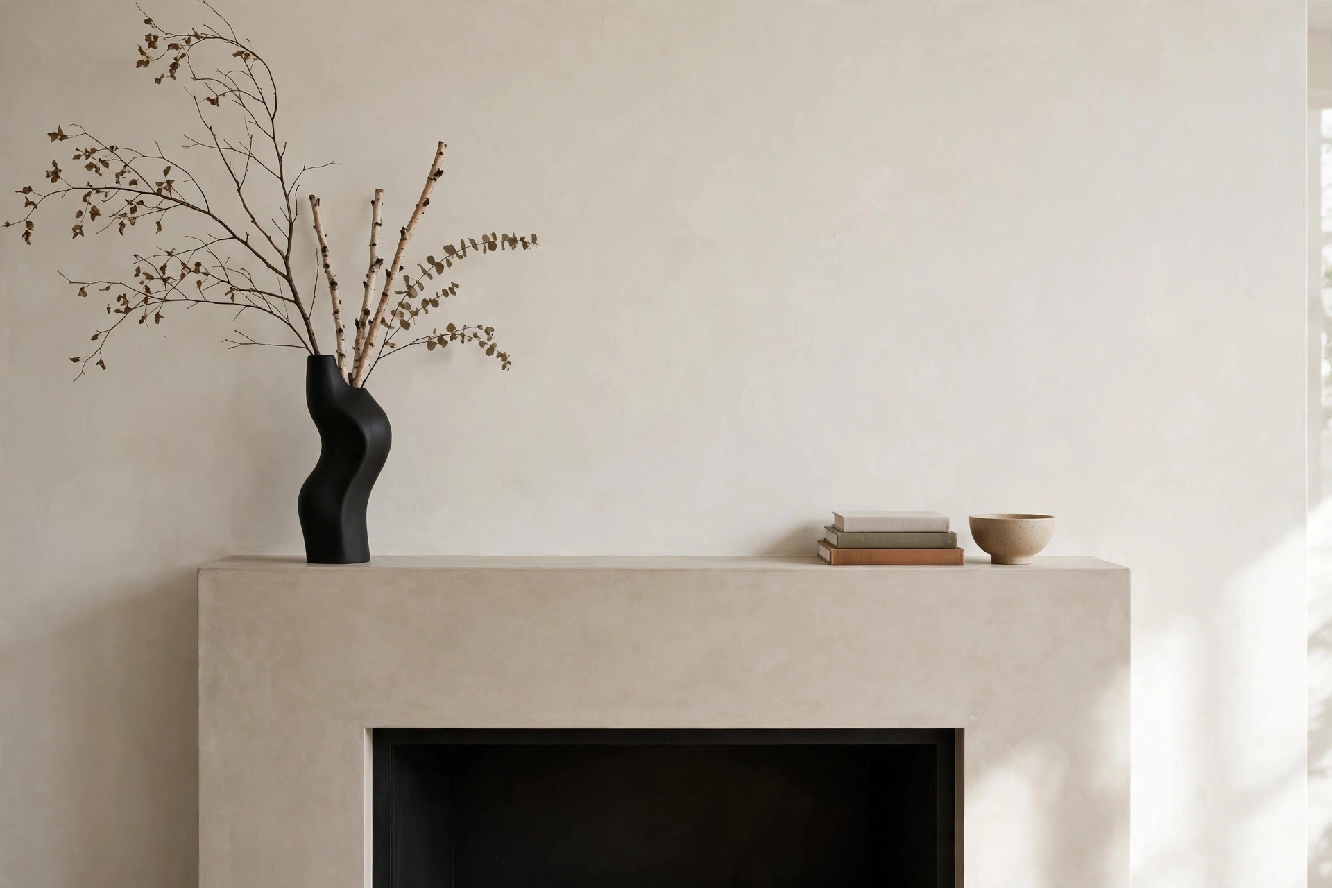 Fireplace mantel decor ideas with modern asymmetrical styling and sculptural objects.